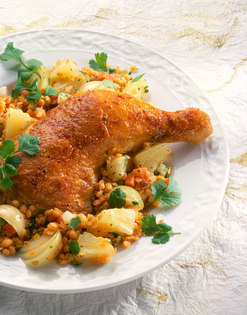 Close-up of chicken legs with lentils on plate