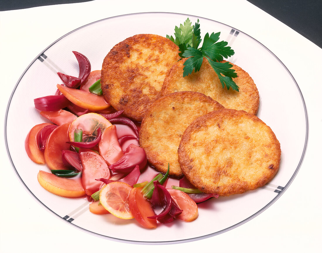 Onions and vegetables with fried food on plate