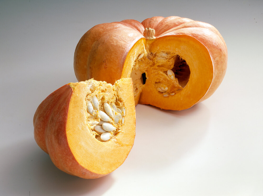 Cut orange pumpkin on white background