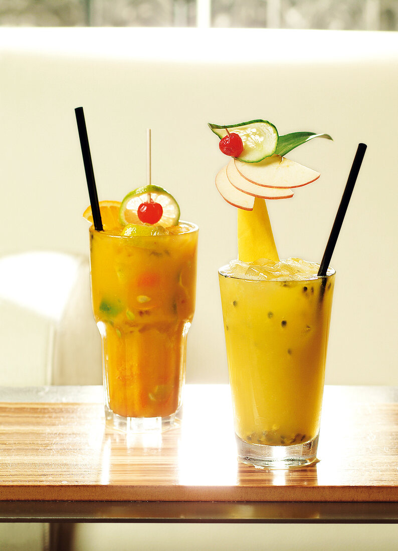 Two fruity cocktails in glasses on table