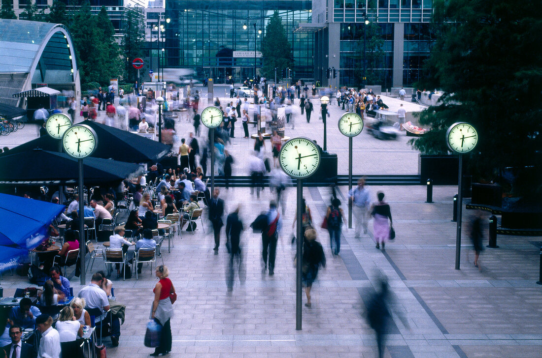 People walking at Nash Court, Docklands, London, England, blurred motion