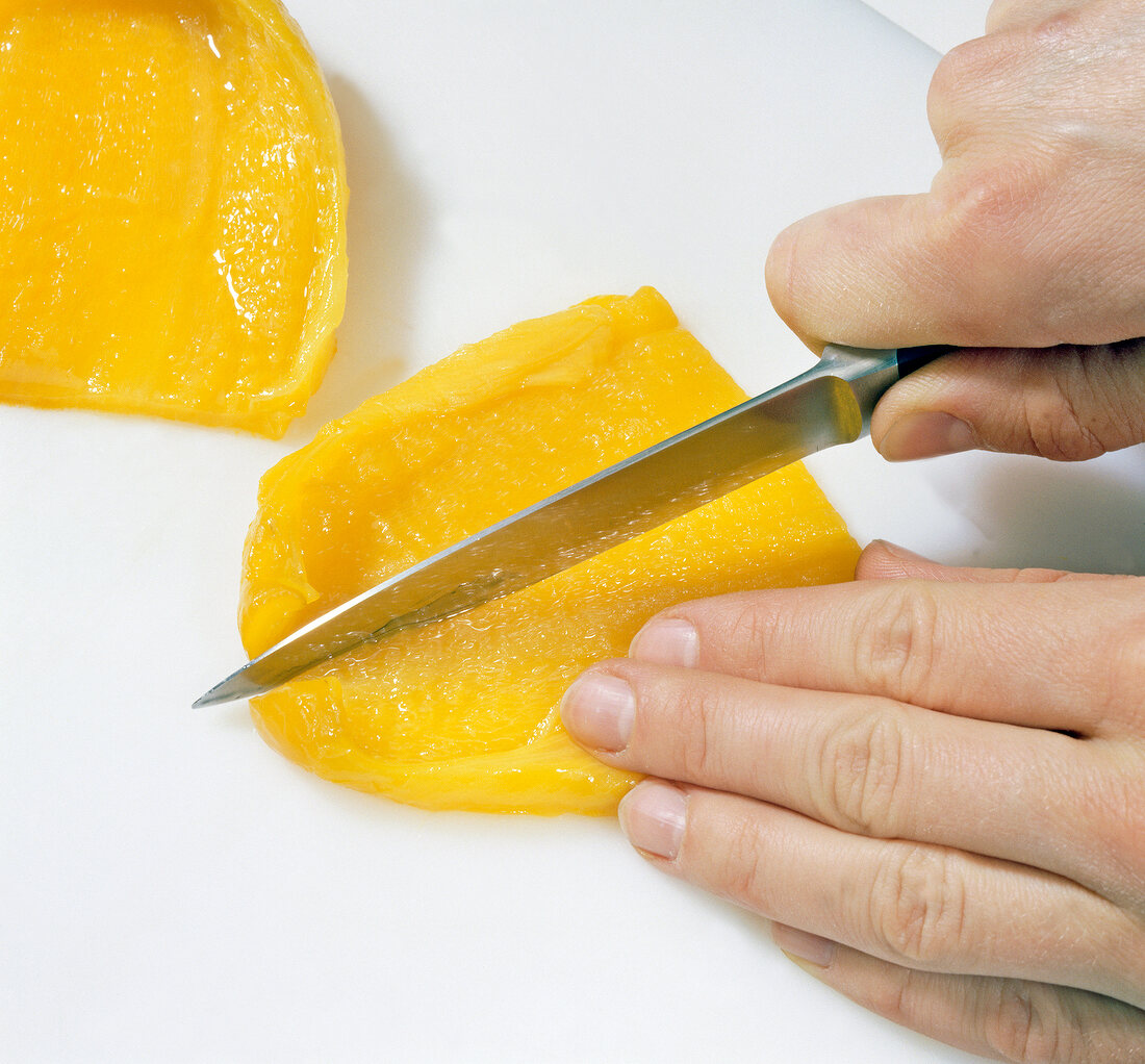 Close-up of hands cutting yellow pepper, step 5