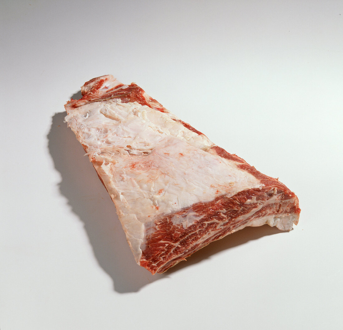 Piece of raw beef meat from leg on white background