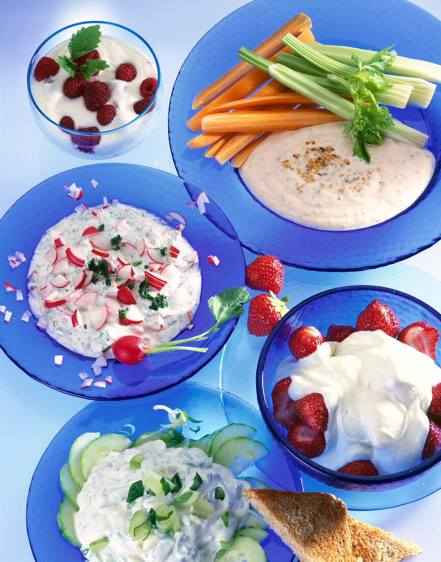 Various dish made from yogurt on blue plates