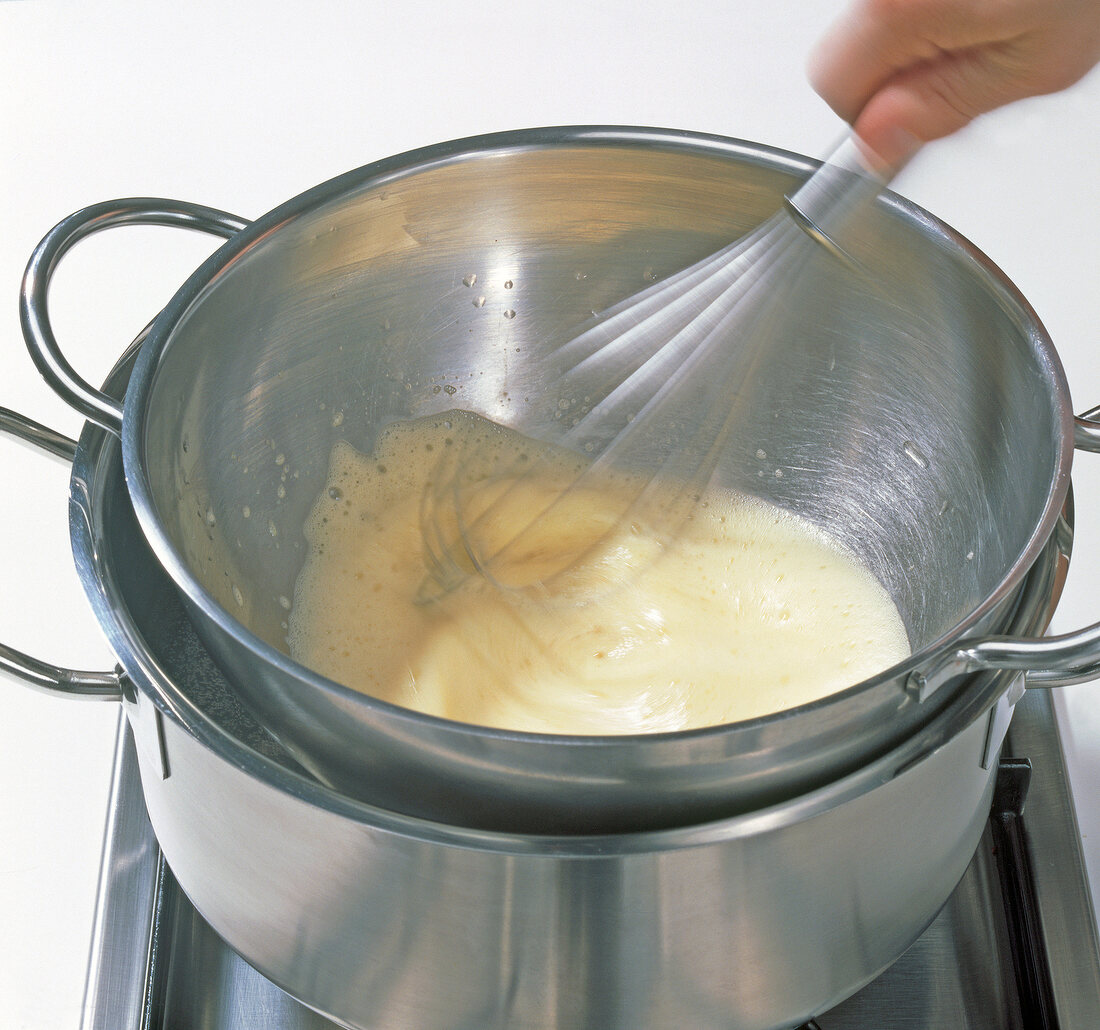 Close-up of eggs being whisked in bowl with whisk