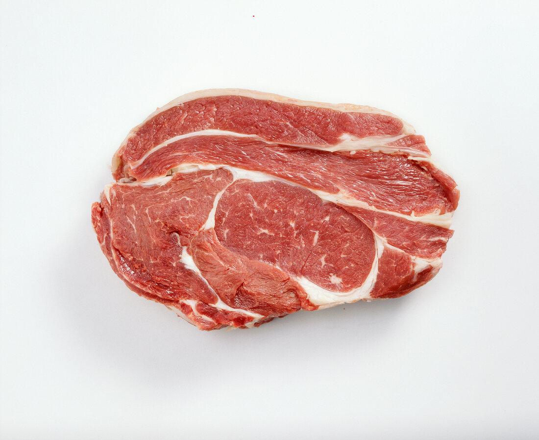 Piece of raw beef meat from high rib on white background
