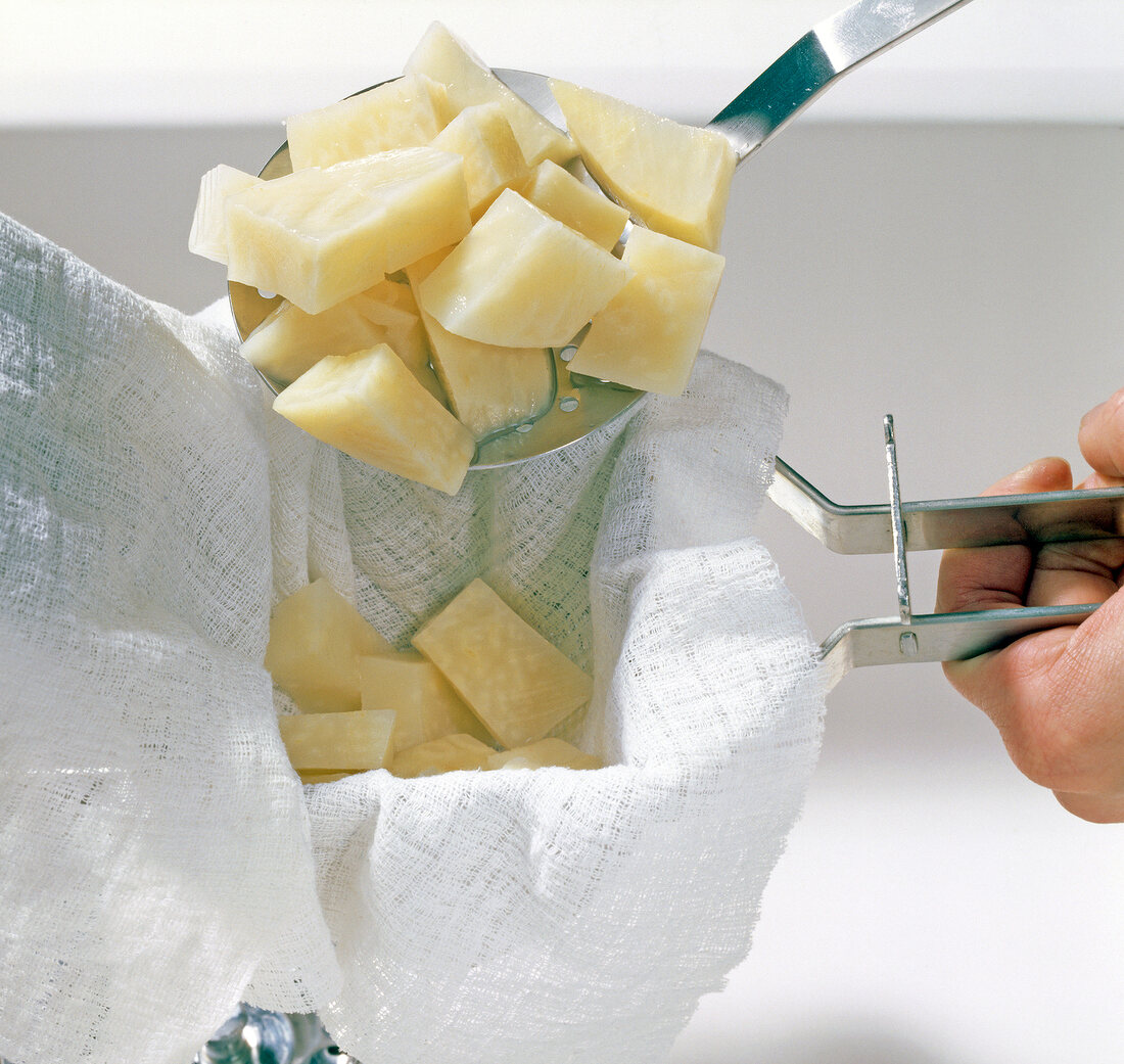 Pieces of celery being put in white cloth, step 1