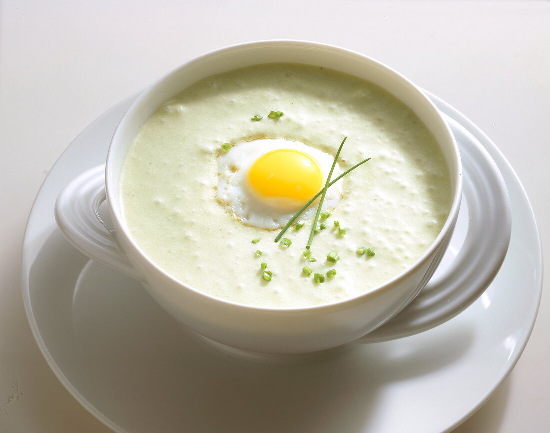 Close-up of potato and leek soup with fried egg in bowl