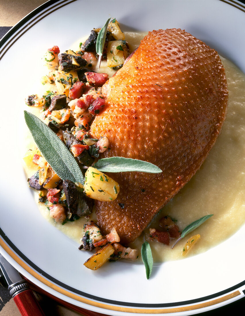 Goose in Irish style with stuffing and sage on plate in serving dish