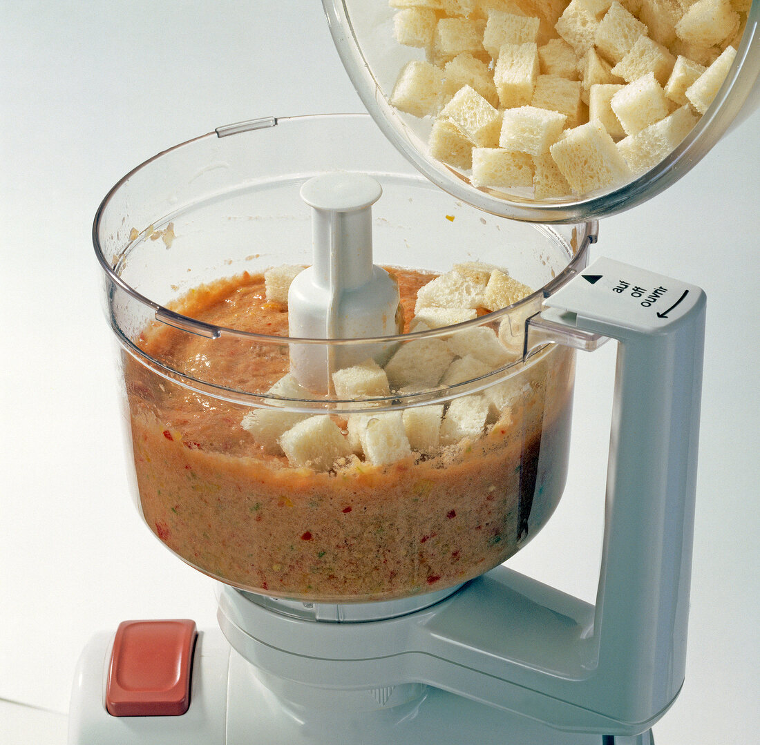 Close-up of adding white bread cubes in blender, step 2
