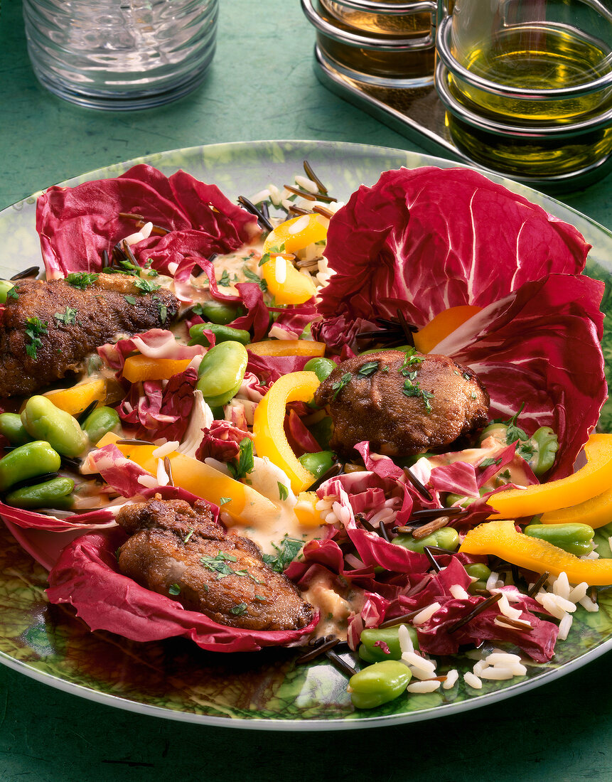 Close-up of radicchio salad with rice and liver on plate