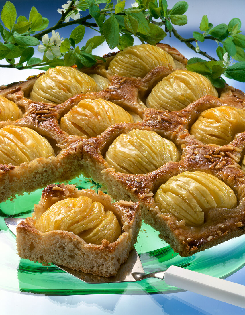 Close-up of toffee apple cake and one piece on spatula