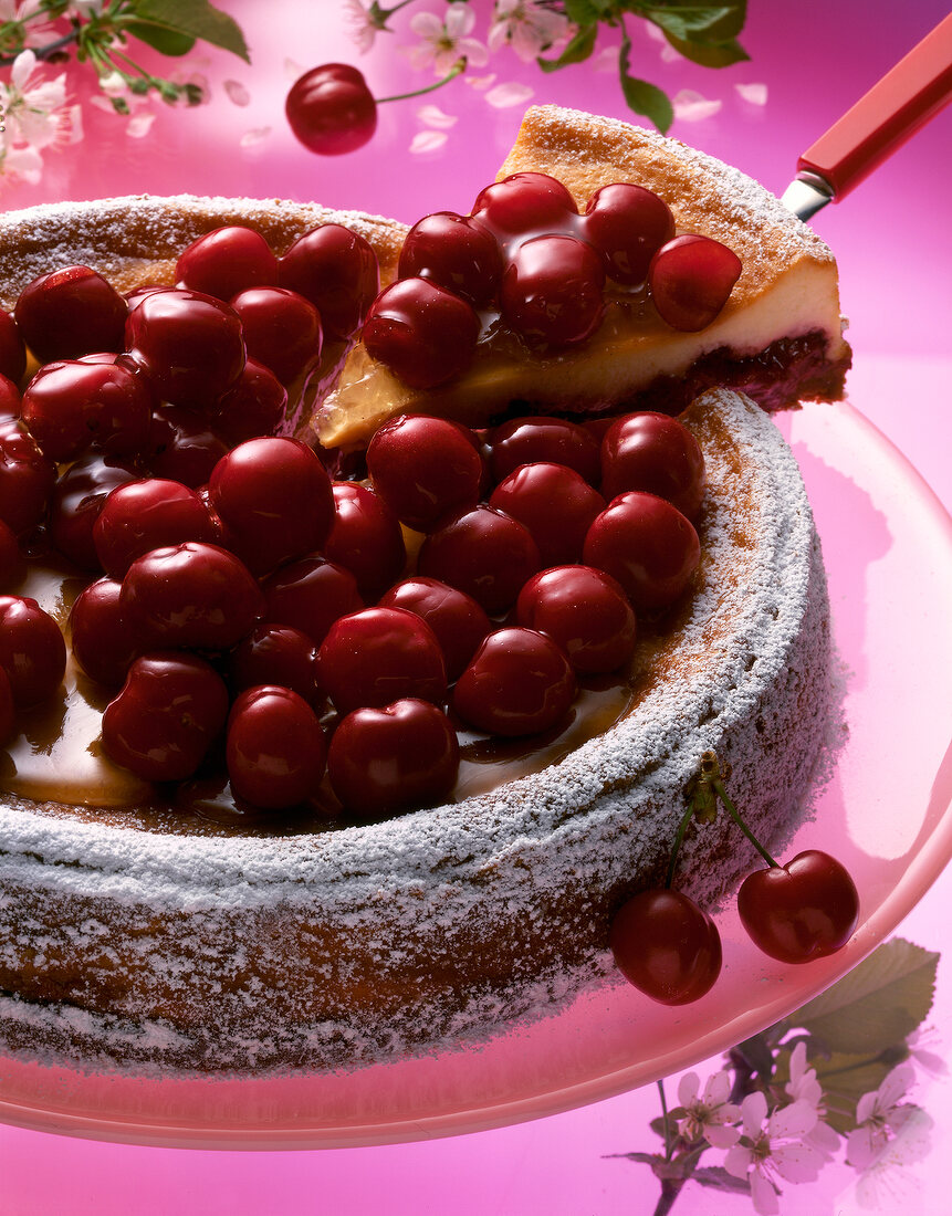 Close-up of cherry cake with piece of cake on spatula