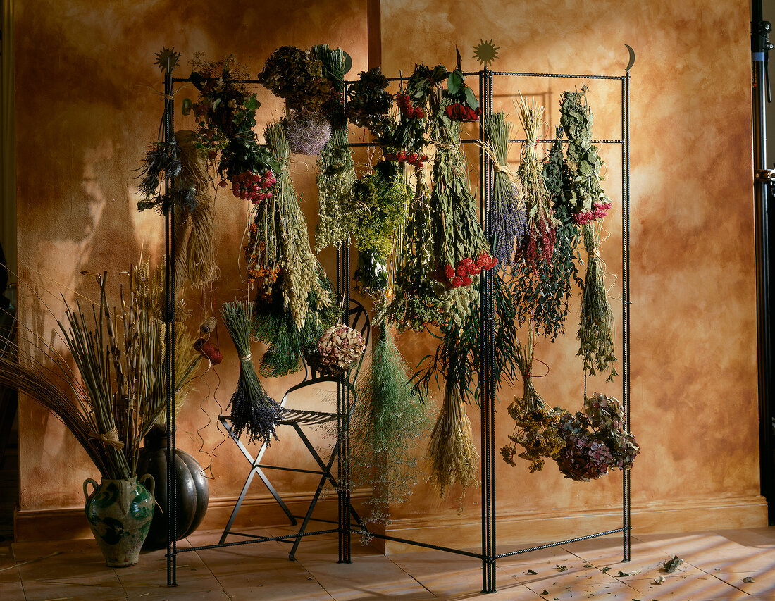 Bouquets hanging on iron rods for drying