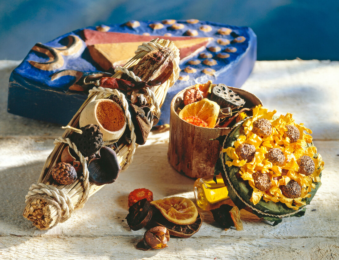 Close-up of dried leaves in bamboo boat and sunflower box