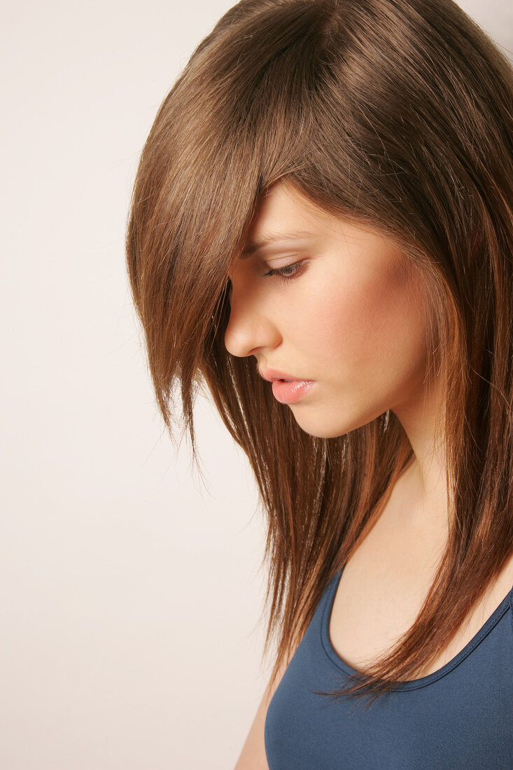 Side view of Magdalena woman with straight long hair, looking down