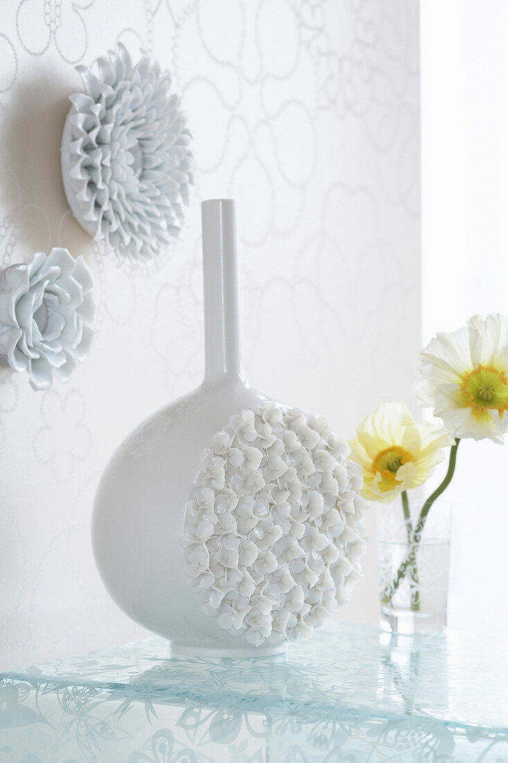 Plastic pattern vase in front of decorated wall