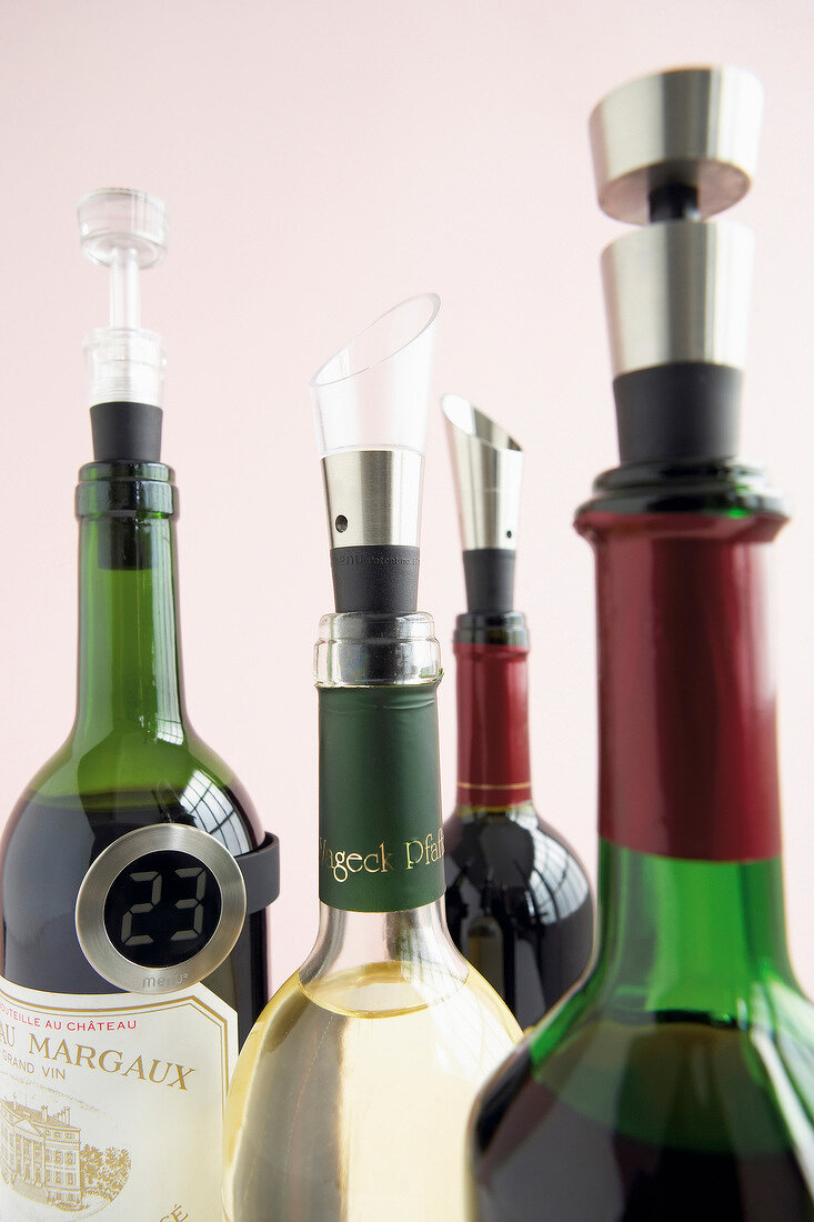 Close-up of wine bottles with spout and thermometer