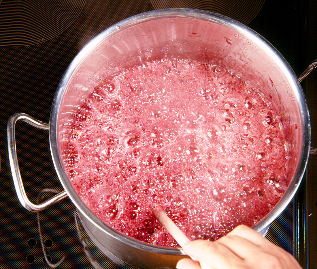 Sour cherry and ginger jam ingredients in the pot for boiling