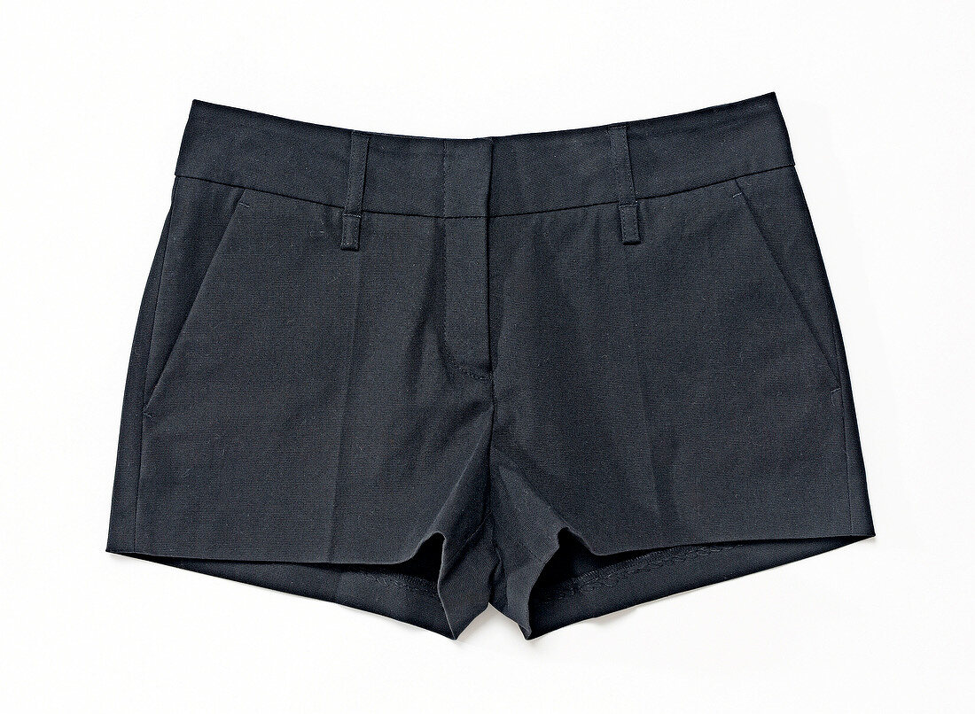 Close-up of short dark shorts on white background