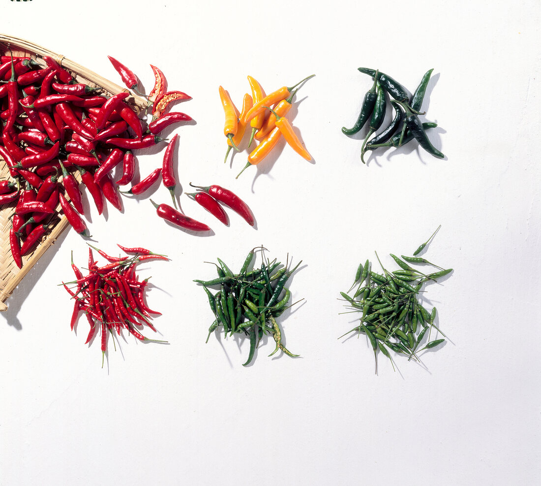 Six different types of chillies on white background