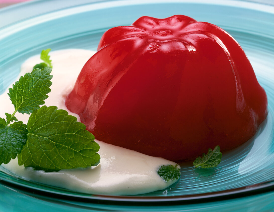 Close-up of watermelon jelly with mascarpone sauce on plate