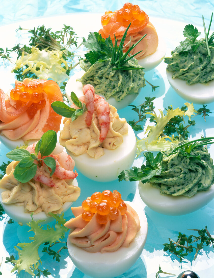 Close-up of stuffed eggs with cream cheese, caviar shrimp and herbs