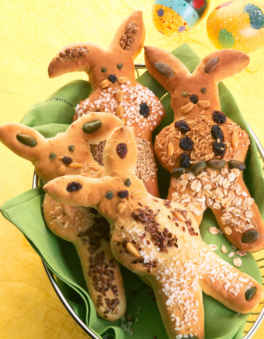 Close-up of bunny shaped buns with shredded coconut, raisins, almonds and nuts