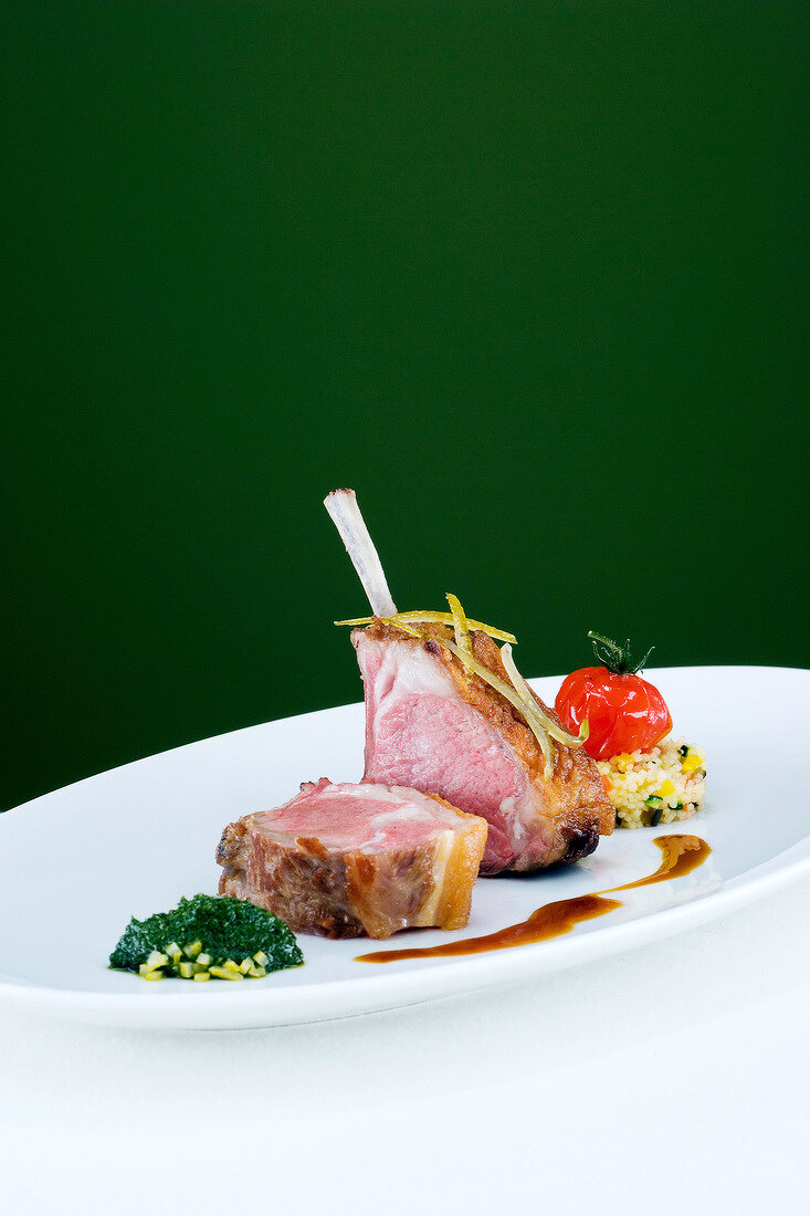 Rack of lamb with coriander puree and vegetable couscous on plate