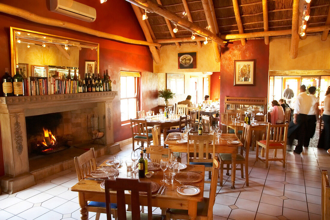 Fire place and table laid at the restaurant, Winery Ken Forrester, South Africa