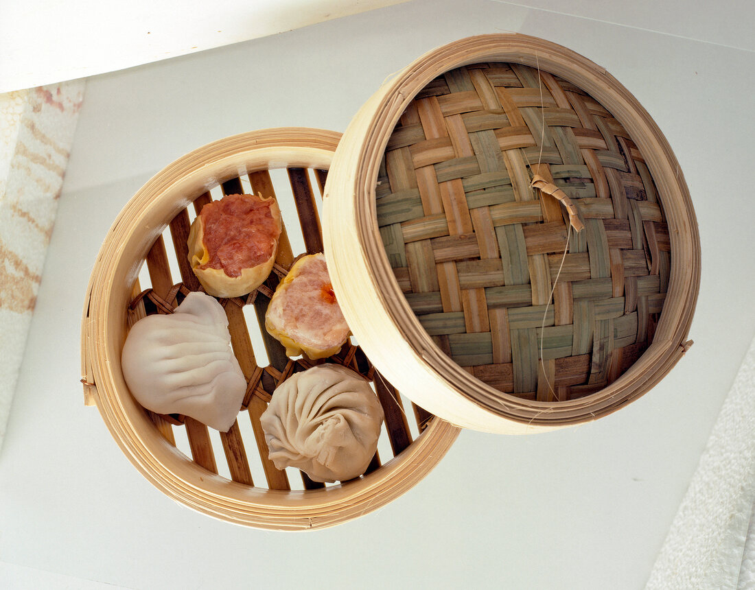 Raw dumplings in bamboo steamer, overhead view