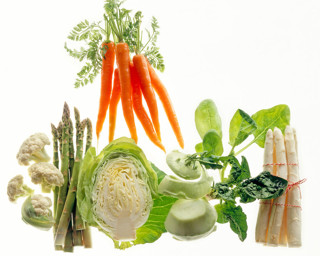 Carrots, cabbage, asparagus and others vegetable against white background