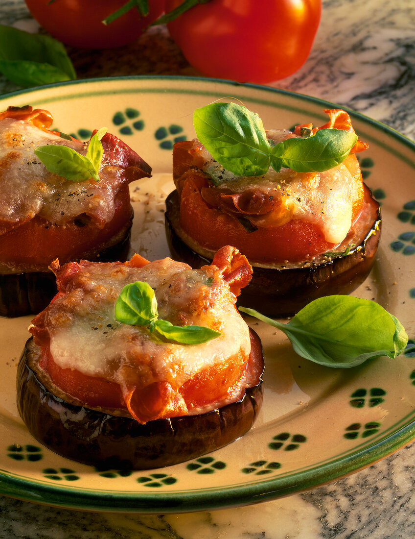 Deep fried eggplant with tomatoes and mozzarella on plate