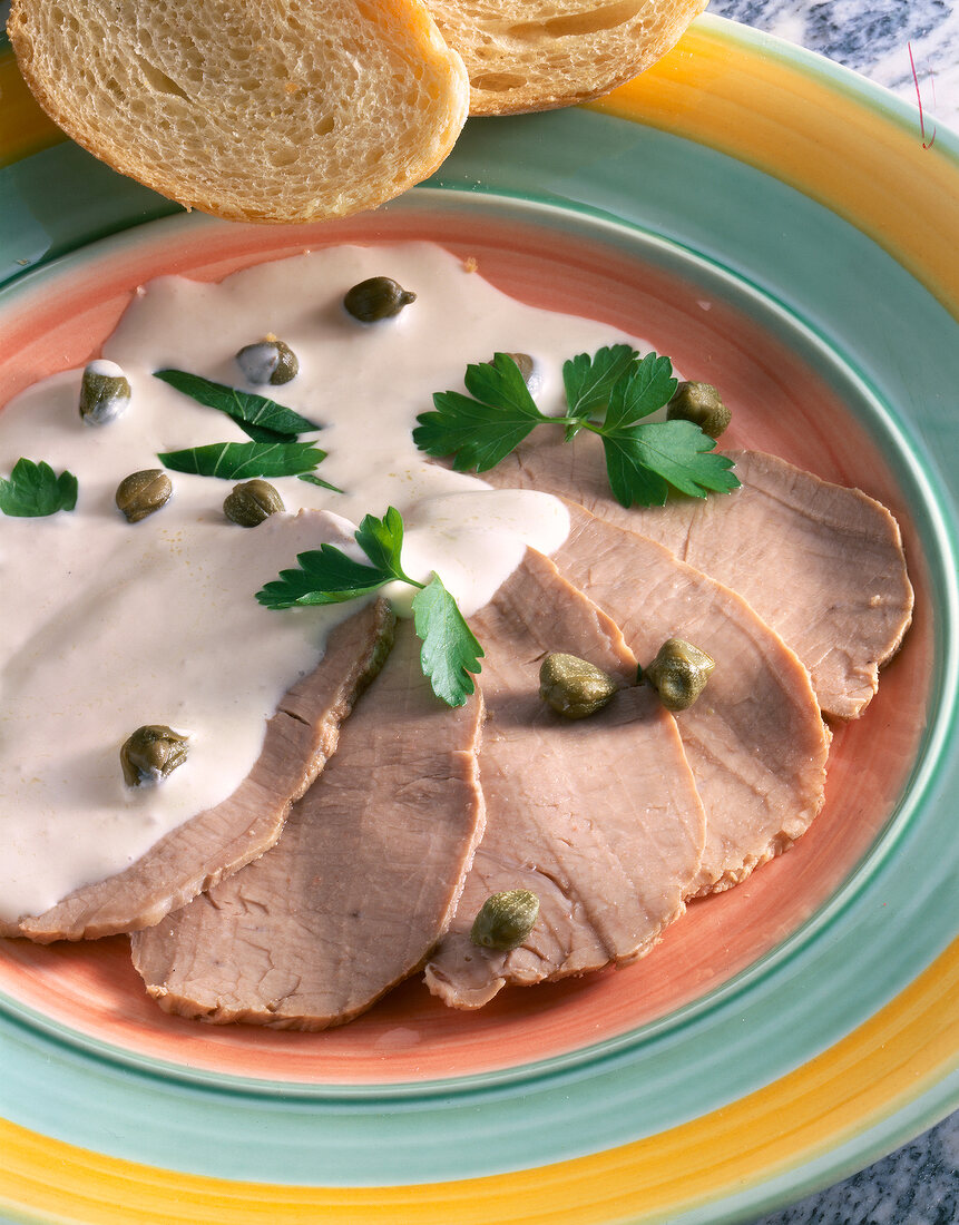Veal meat with tuna sauce and capers herb on plate