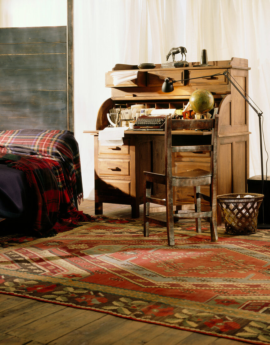 Colonial style room with wooden secretary desk and chair in workplace