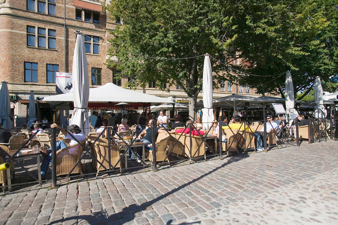 People sitting at cafe in Lilla Torg, Malmo, Sweden