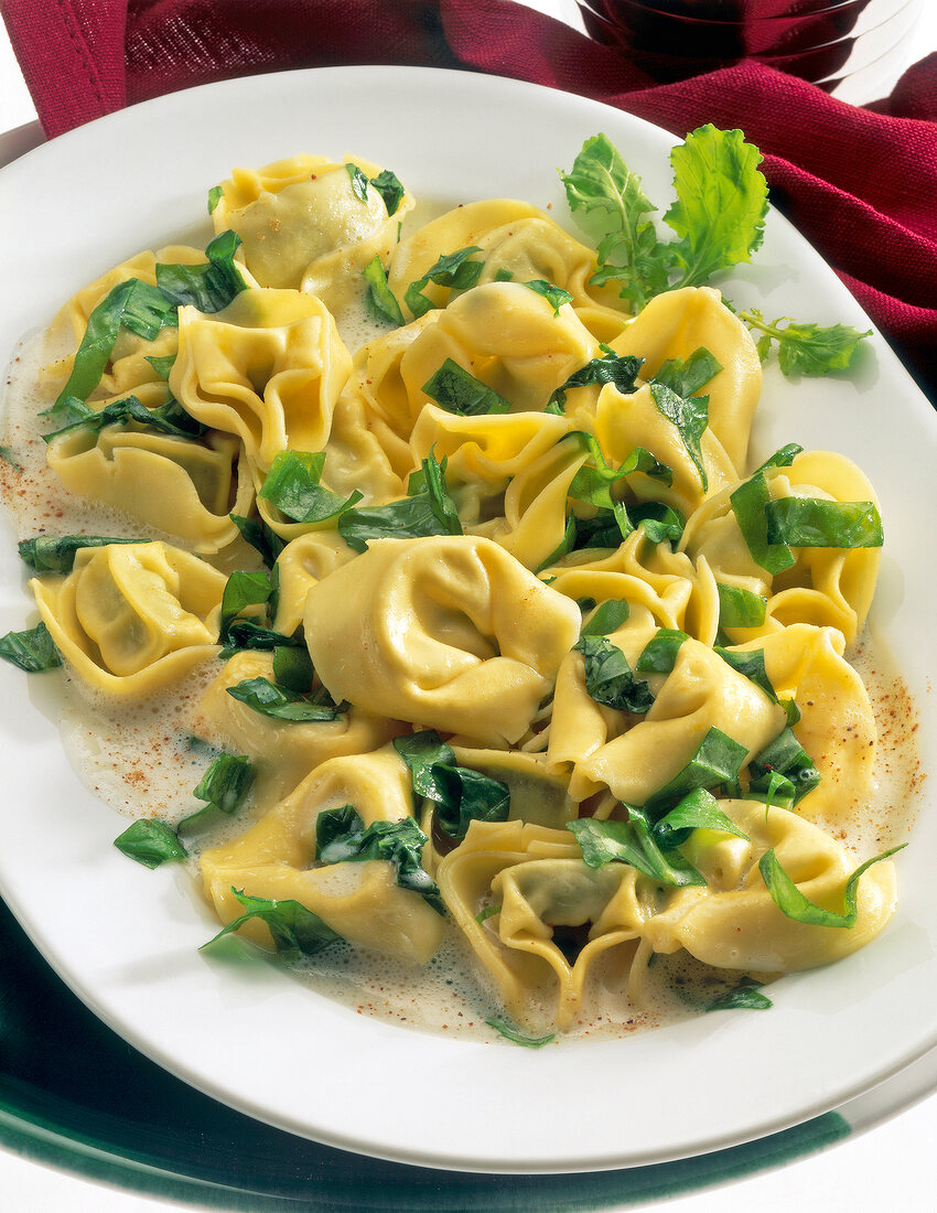 Close-up of Tortellini with rocket salad on plate