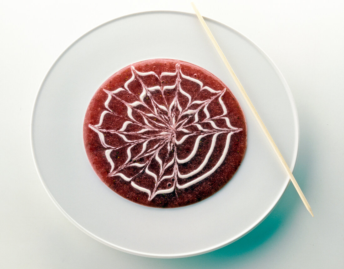 Dessert designed in shape of spider web with chopstick
