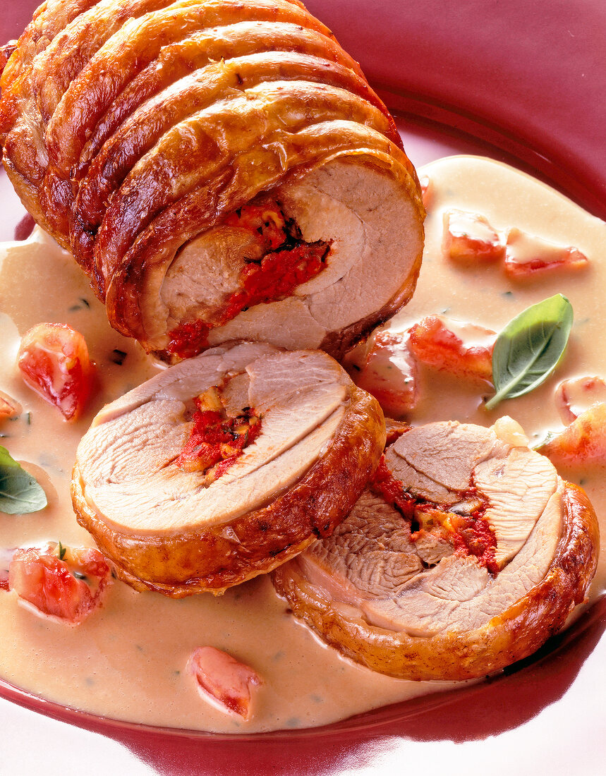 Close-up of roast turkey with cheese, tomato and basil sauce