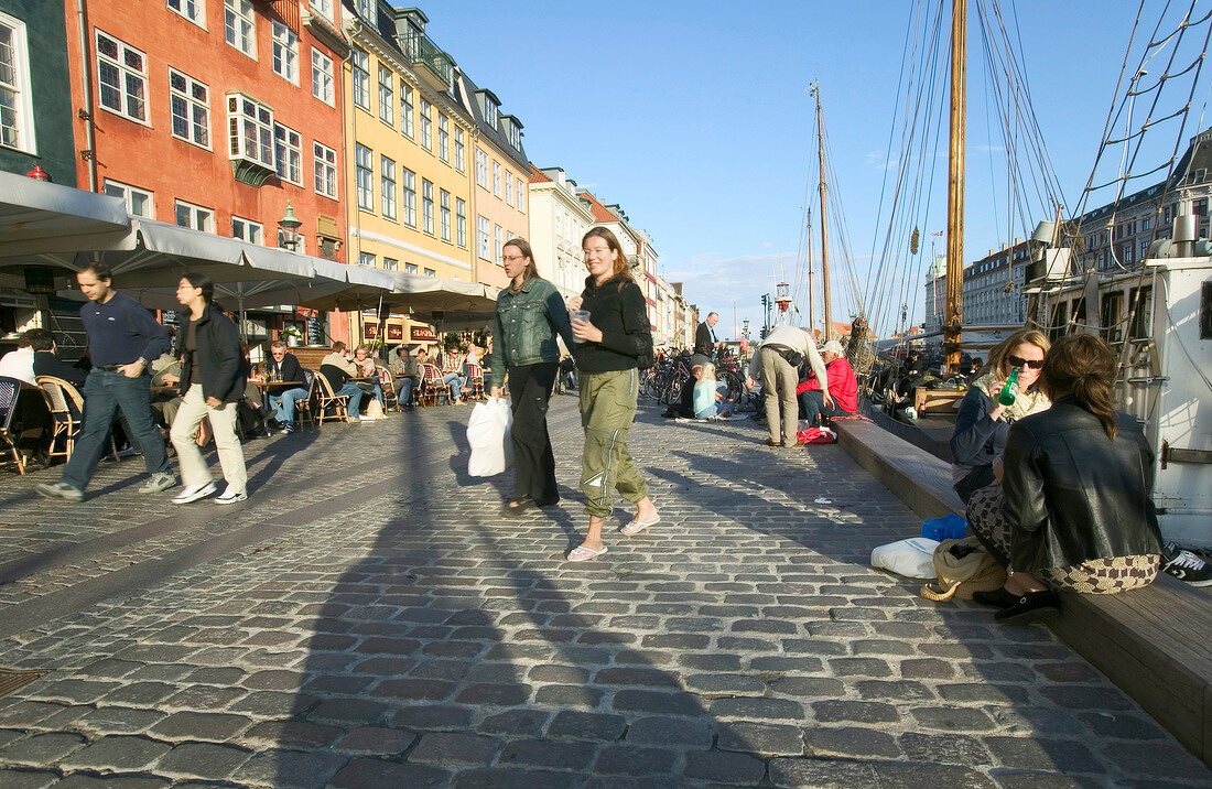 People at Nyhavn Canal in Copenhagen, Denmark
