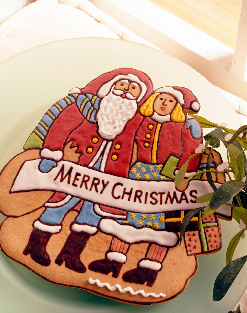 Lebkuchen bunt bemalt in Form von Weihnachtsmann + -frau mit Gruß