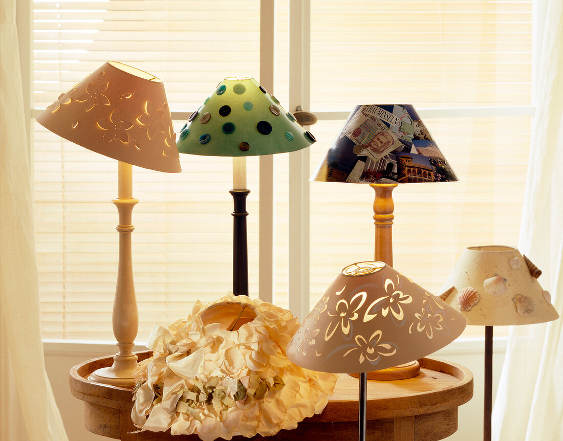 Close-up of variety of lamp heads with paper, buttons and fabric