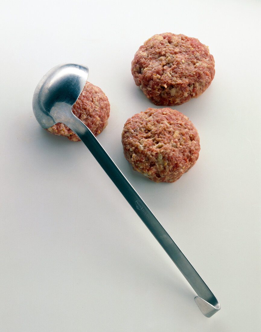 Close-up of meatballs with trowel shapes on white background