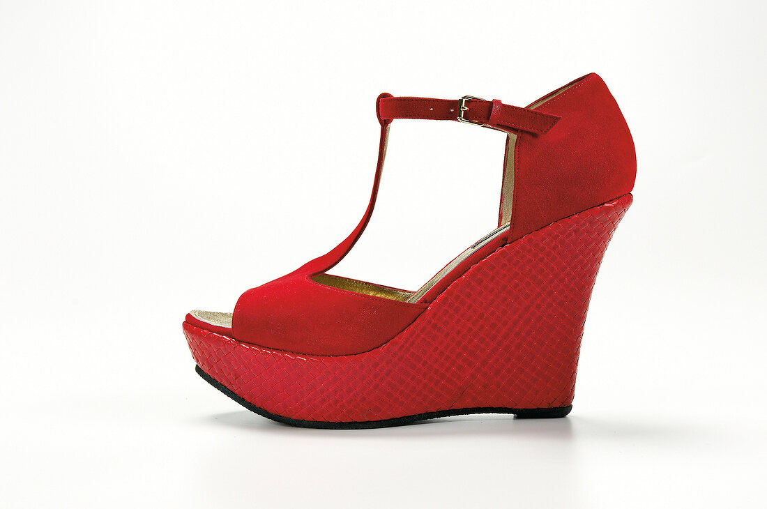 Red wedge heel on white background