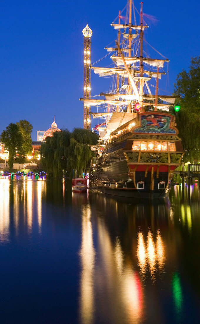 Illuminated old pirate ship at Tivoli Gardens in Copenhagen, Denmark