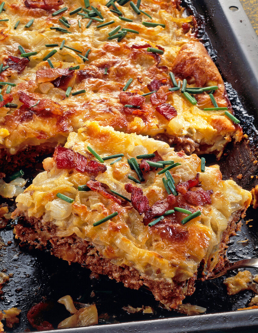 Hackfleisch-Zwiebel-Kuchen mit Bacon und Kümmel auf Blech