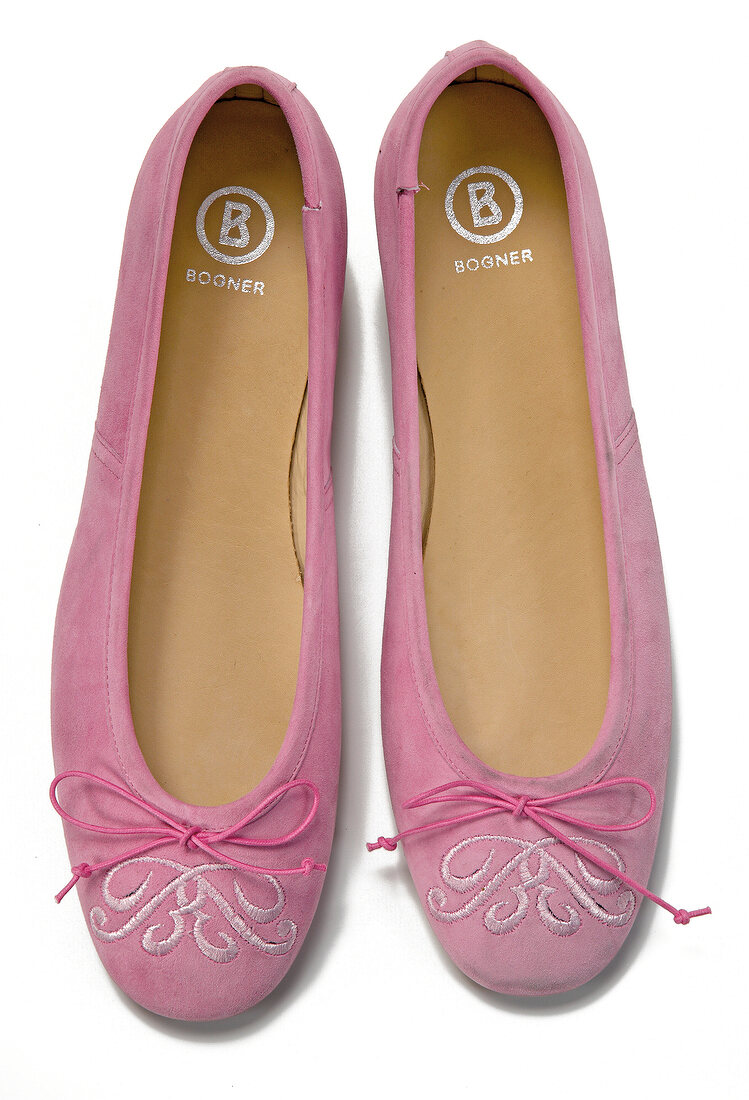 Close-up of pink ballerinas on white background
