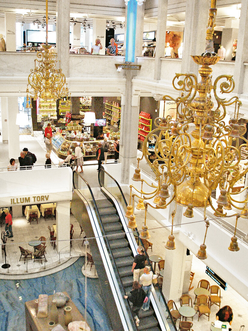 Interior of Illum shopping mall with escalator and chandeliers