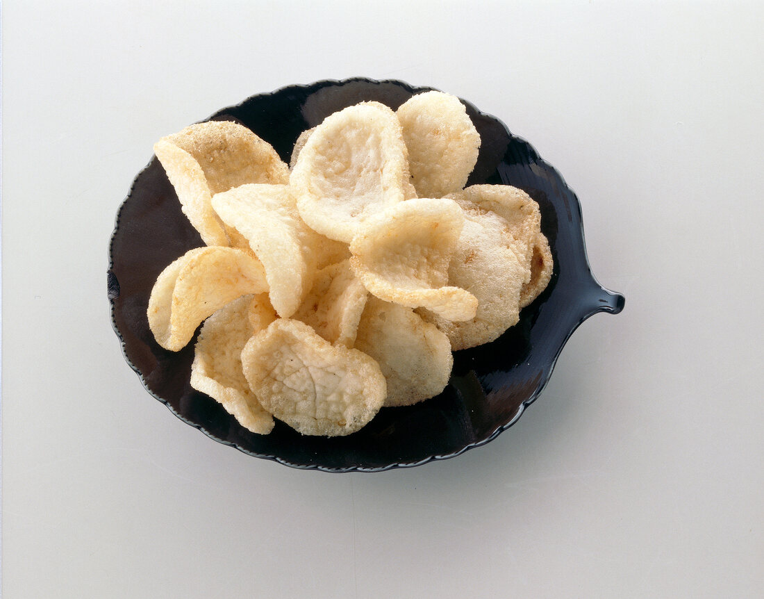 Crab chips in black serving dish