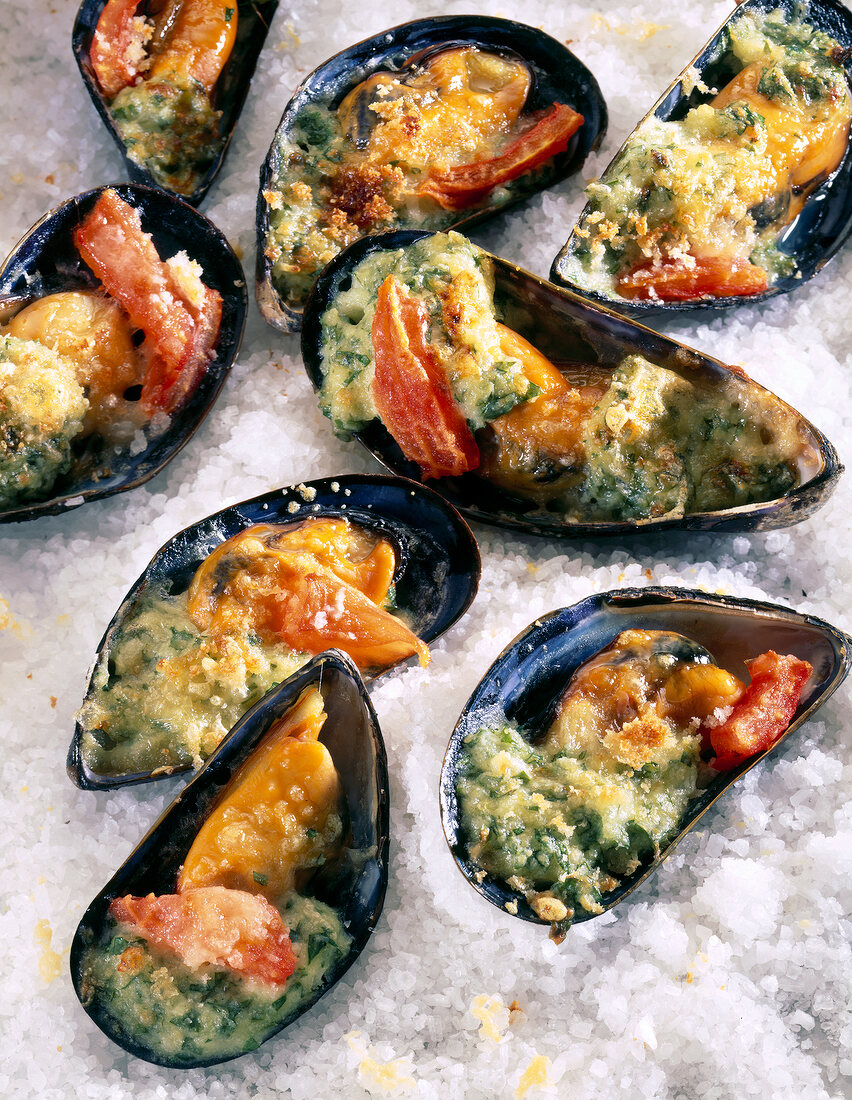 Baked mussels with tomatoes and cream cheese on a bed of rice